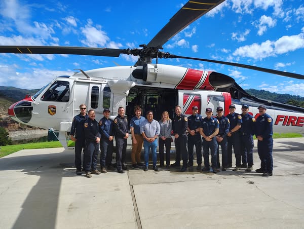 Staffers Mario Lopez, Suzanne Wheaton, and Zachary Contini posed with CAL FIRE in front of new Fire Hawk Helicopter