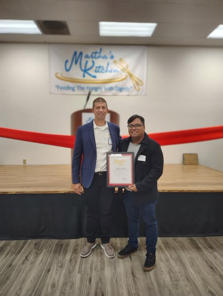 Staffer Mario Lopez with Martha’s Kitchen community leader