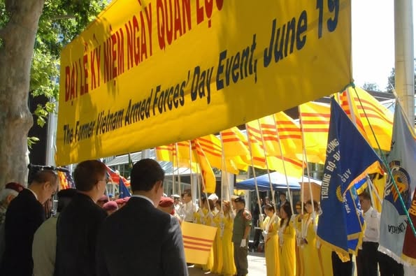 Vietnamese flags and a banner, held by community members at the Former Vietnam Armed Forces’ Day Event 