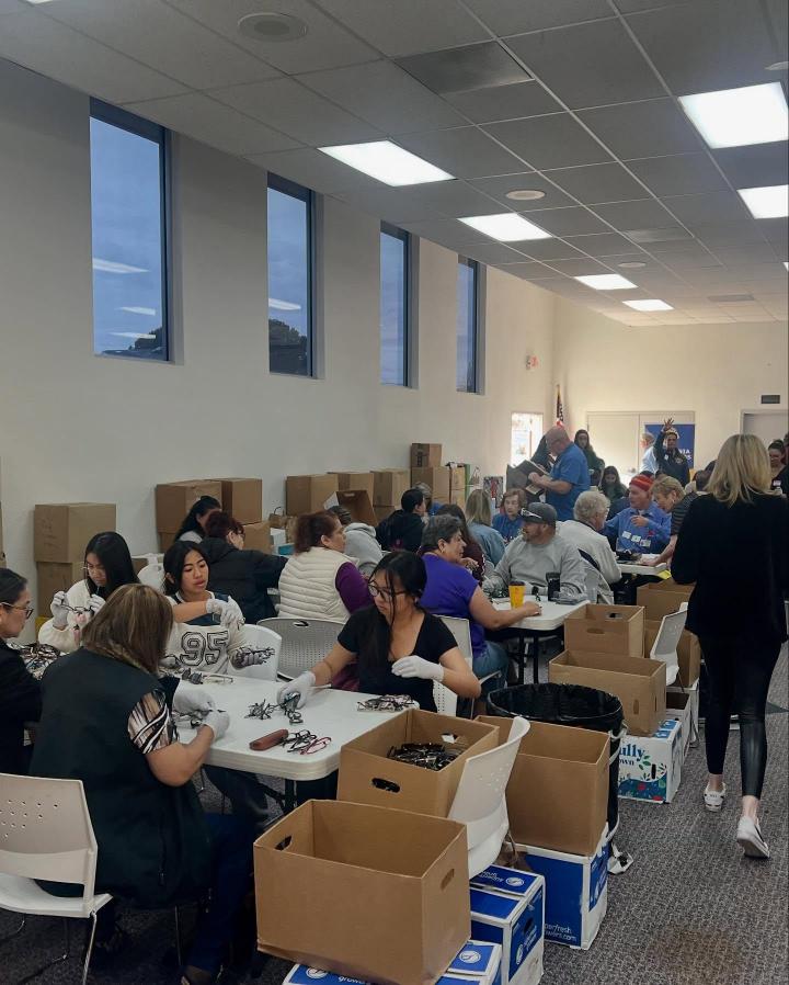 Community members recycling at tables.