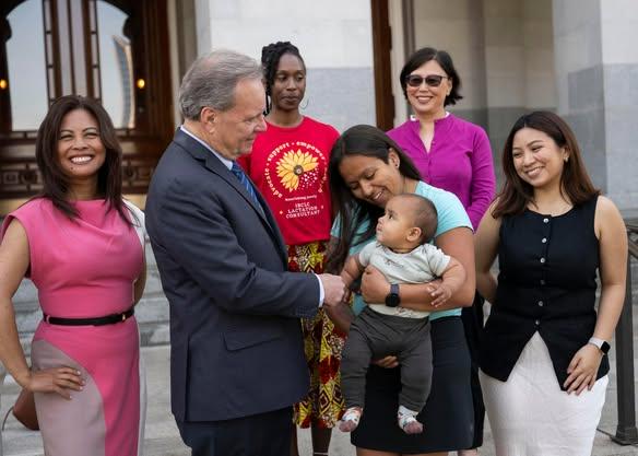Senator Cortese photographed with a young child and members of Mother’s Milk Bank