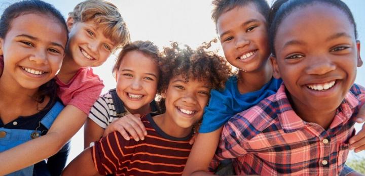 Six children smiling for a photograph.