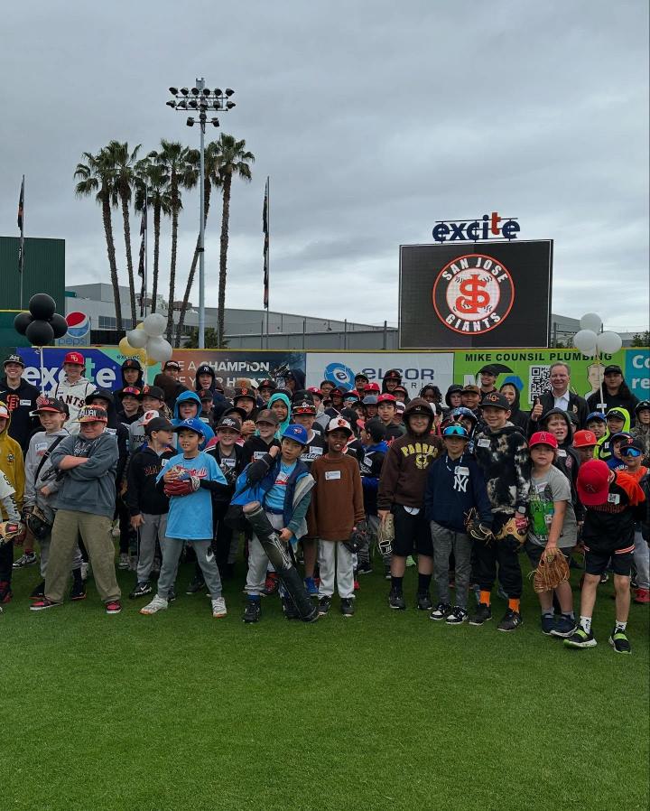 Senator Cortese among a crowd of young children in baseball gear.