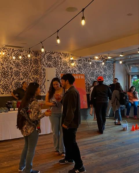 Community members networking with refreshments in hand
