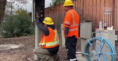 Caltrans workers photographed fixing a traffic light