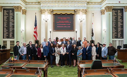Senator Cortese speaking under a sign that reads “Speaker Robert Rivas Welcomes Elected Leaders from Assembly District 29 to the Assembly Floor. Wednesday, April 9, 2025.”