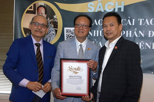 District Representative presenting a Senate certificate to members of the Vietnamese Cultural Center
