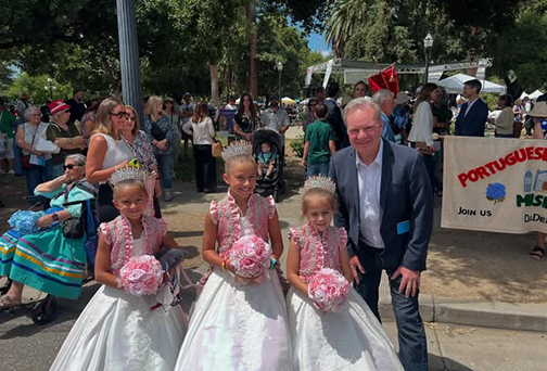 Senator Cortese photographed with young girls in traditional Portuguese attire