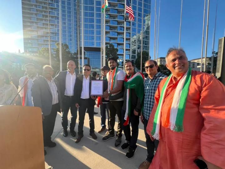 Staff member Phuong Nguyen photographed at Flag-Raising Ceremony alongside various community leaders