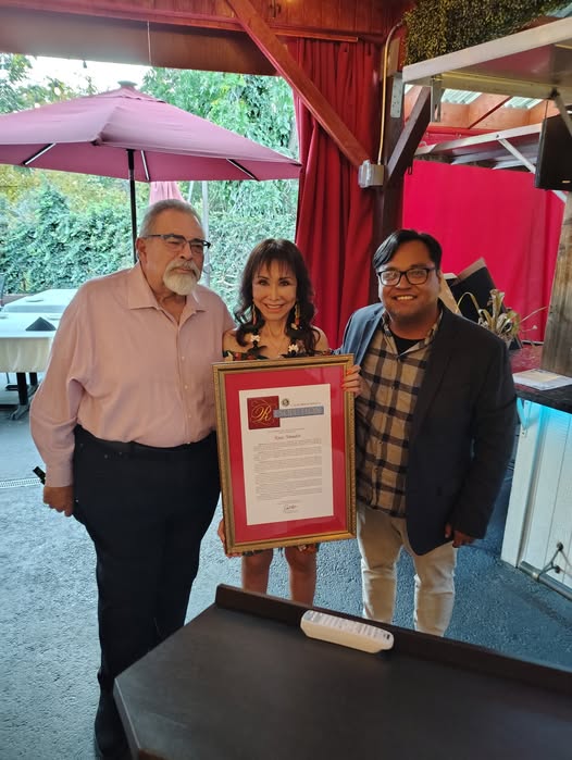 Staffer Mario Lopez photographed presenting a Resolution to Rose Amador