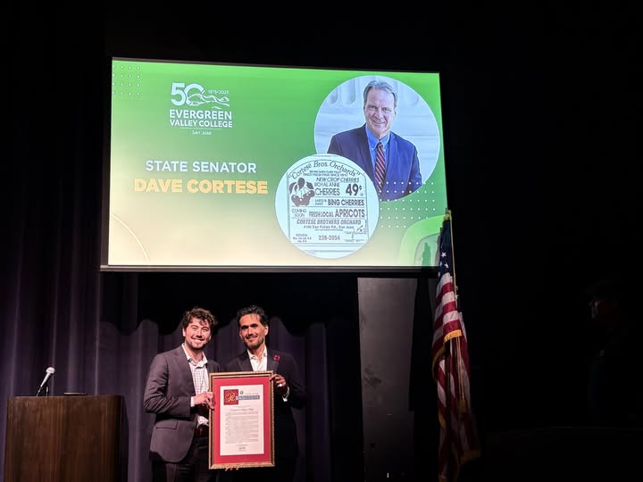 Staffer Zach Contini presenting a Resolution to President Vinicio Lopez