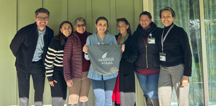 Staffer Mariam Ghallab photographed with Momentum for Health leaders