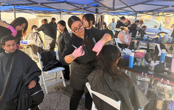 Volunteer barbers cutting hair at Senator Cortese’s Unhoused Health Fair